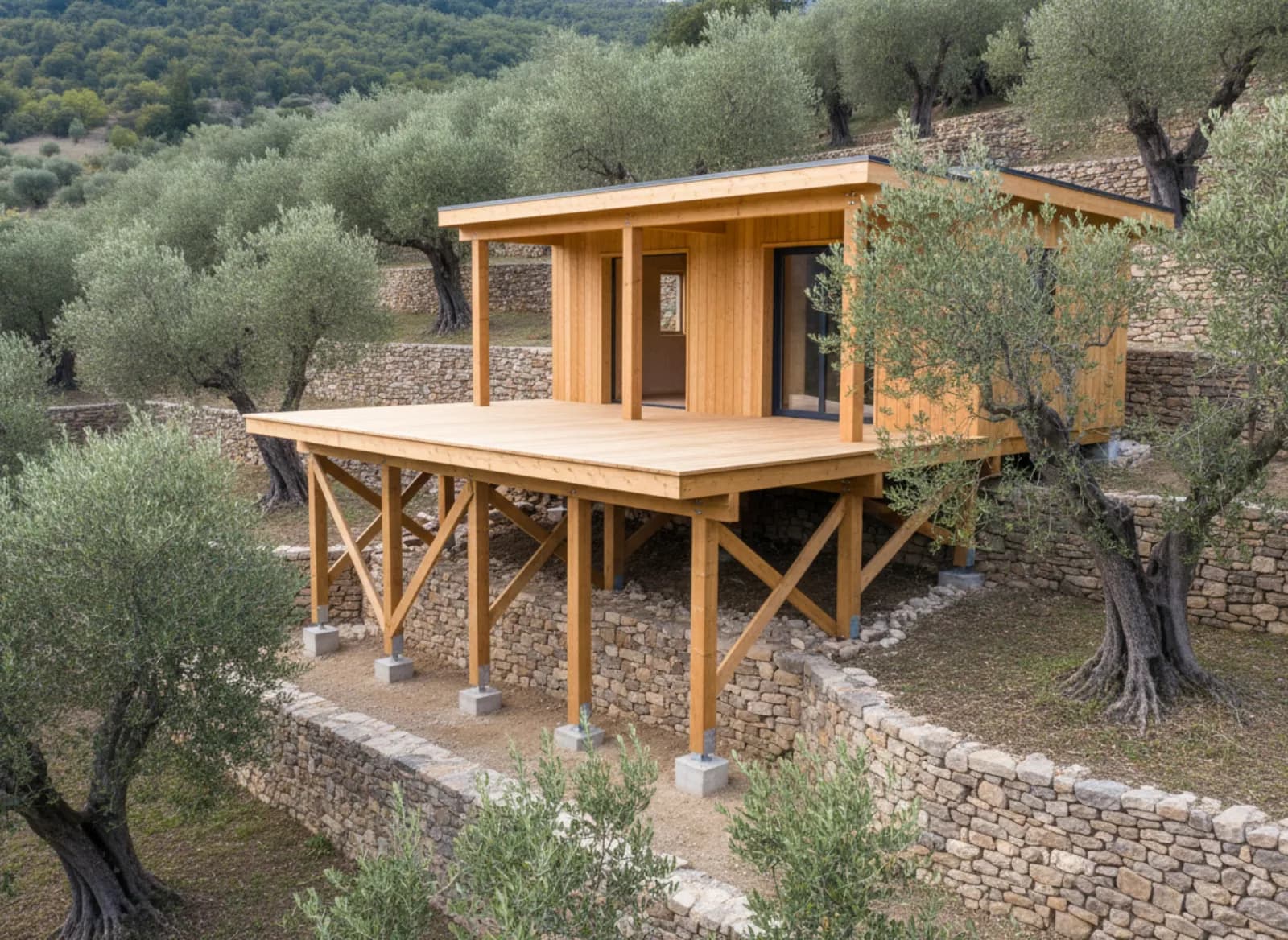 Cabane sur pilotis sur un terrain en restanques, entre murs de pierre sèche et oliviers
